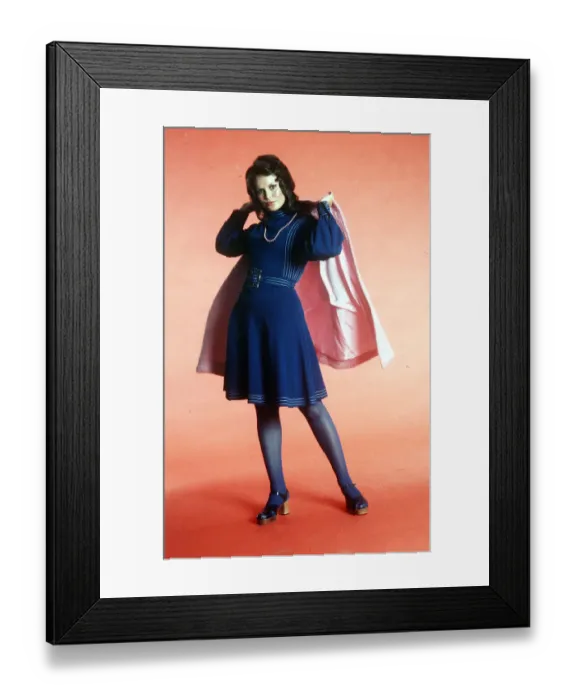 Framed Print : Seventies fashion 1970s model wearing blue A-line dress with sandals and pink cape Framed Print : Seventies fashion 1970s model wearing blue A-line dress with sandals and pink cape