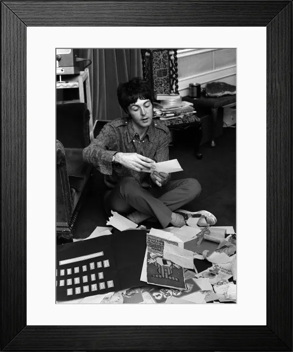 Framed Print : Paul McCartney of The Beatles sitting on the floor cross legged as he opens up birthday Framed Print : Paul McCartney of The Beatles sitting on the floor cross legged as he opens up birthday