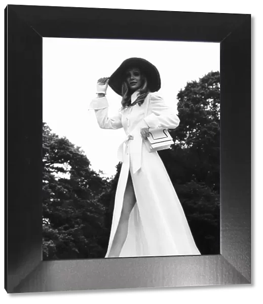 Model wears long white coat at Royal Ascot in June 1969 with floppy hat