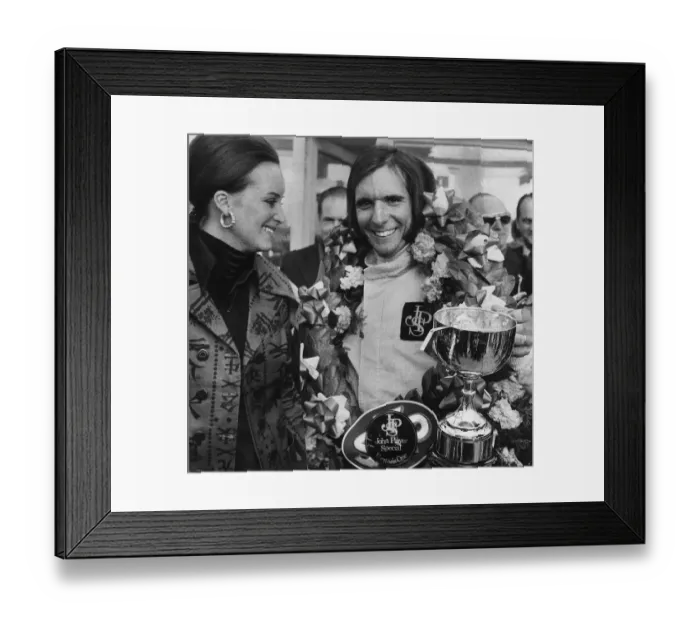Framed Print : Emerson Fittipaldi wins the British Grand Prix at Brands Hatch stands with wife Marina