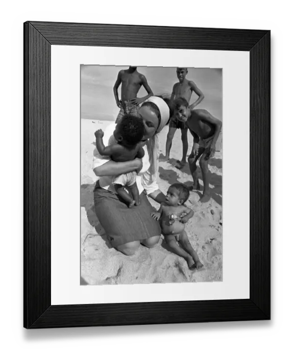 Framed Print : Youth worker cuddling babies on the beach in Brazil beaches baby with a Framed Print : Youth worker cuddling babies on the beach in Brazil beaches baby with a