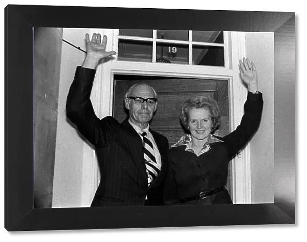 Conservative politician Margaret Thatcher waves at the front door of her home with
