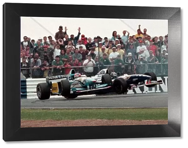 Damon Hill in a Williams and Michael Schumacher in a Beneton collide in the British Grand