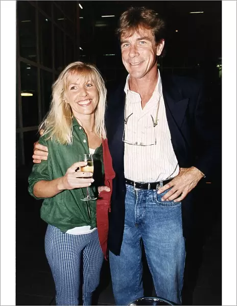 James Hunt racing driver with arm around Helen Dyson