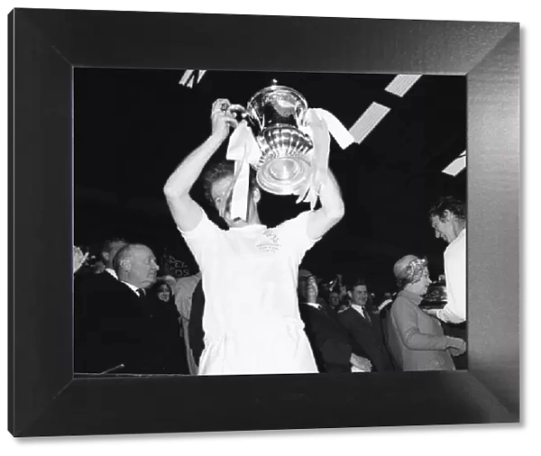 Billy Bremner Leeds United captain holds the cup aloft moment after being presented with