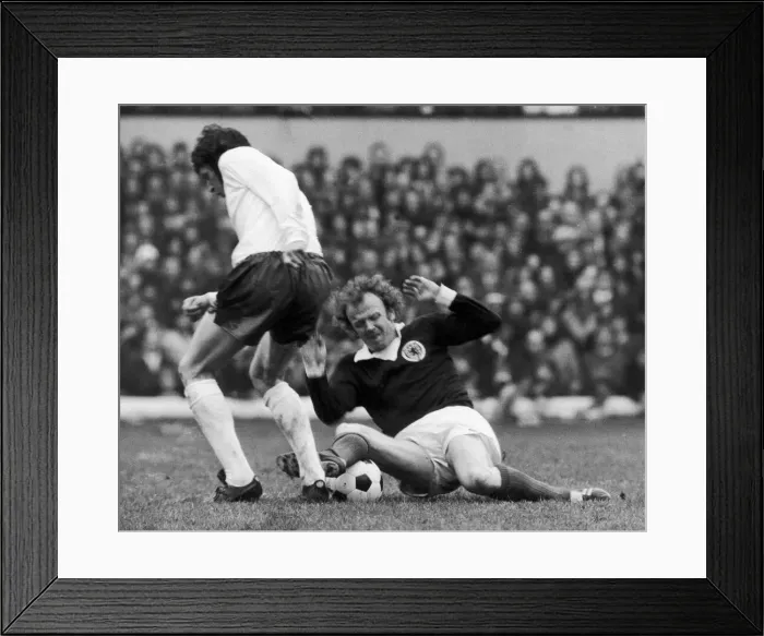 Framed Print : Billy Bremner in action against a un-named English player during Scotland