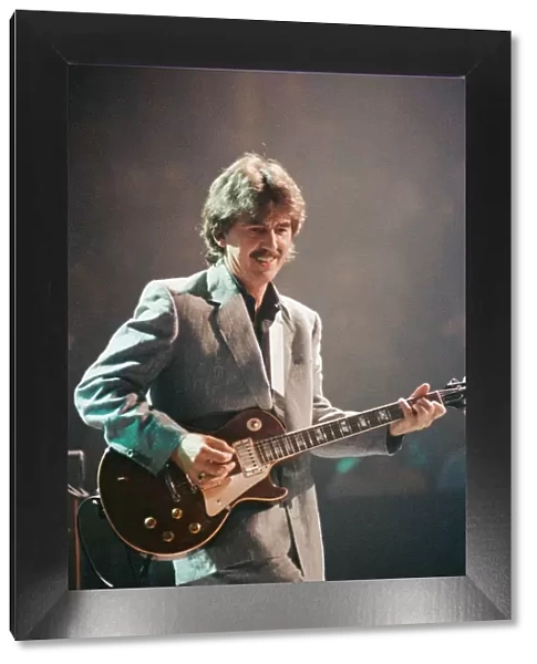 George Harrison ex Beatles Playing the guitar at the Gary Moore concert at the Royal