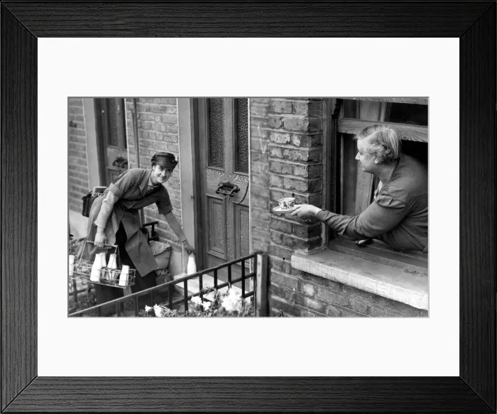 Framed Print : May Pearce, a milk girl, being given a cup of tea by her mother. 29th November 1942 Framed Print : May Pearce, a milk girl, being given a cup of tea by her mother. 29th November 1942
