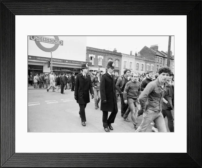 Framed Print : Police keep an eye on Leeds United supporters at the Arsenal football ground as fans