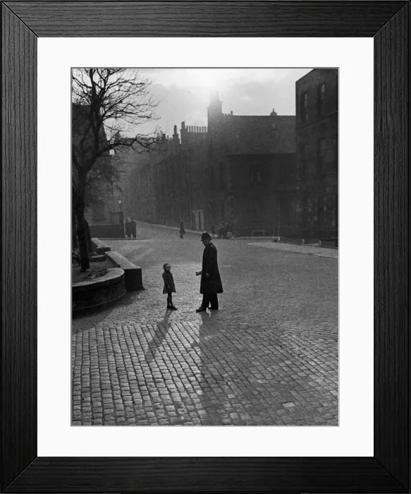 Framed Print : Edinburgh street scenes, Policeman talking to lost child on a cobbled street in Framed Print : Edinburgh street scenes, Policeman talking to lost child on a cobbled street in