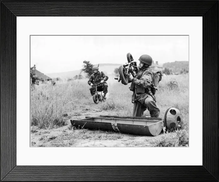 Framed Print : Paratrooper assembles his folding motor scooter - a. k. a Framed Print : Paratrooper assembles his folding motor scooter - a. k. a