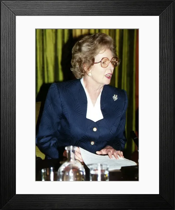 Framed Print : Lady Margaret Thatcher sitting at a table at a press conference wearing glasses Framed Print : Lady Margaret Thatcher sitting at a table at a press conference wearing glasses