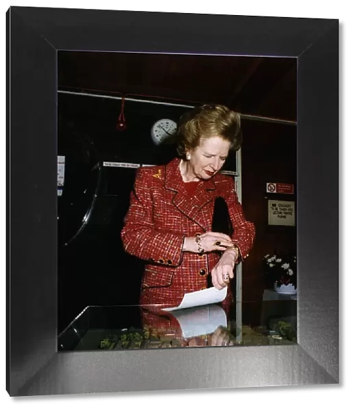 Margaret Thatcher looking at a model of the promised £