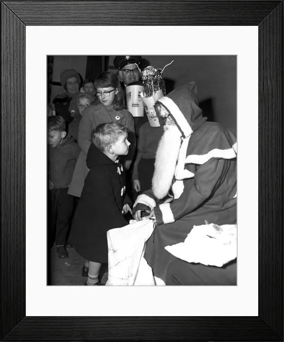 Framed Print : Santa Claus gives a little boy a present at St. John Ambulance bazaar, Holyhead Road Framed Print : Santa Claus gives a little boy a present at St. John Ambulance bazaar, Holyhead Road