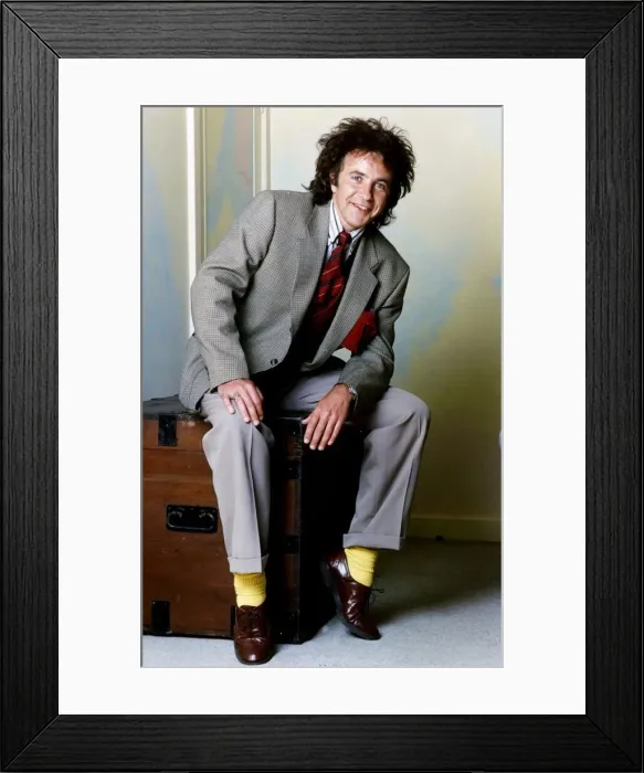 Framed Print : David Essex Singer sitting on a blanket box wearing a suit and yellow socks Framed Print : David Essex Singer sitting on a blanket box wearing a suit and yellow socks