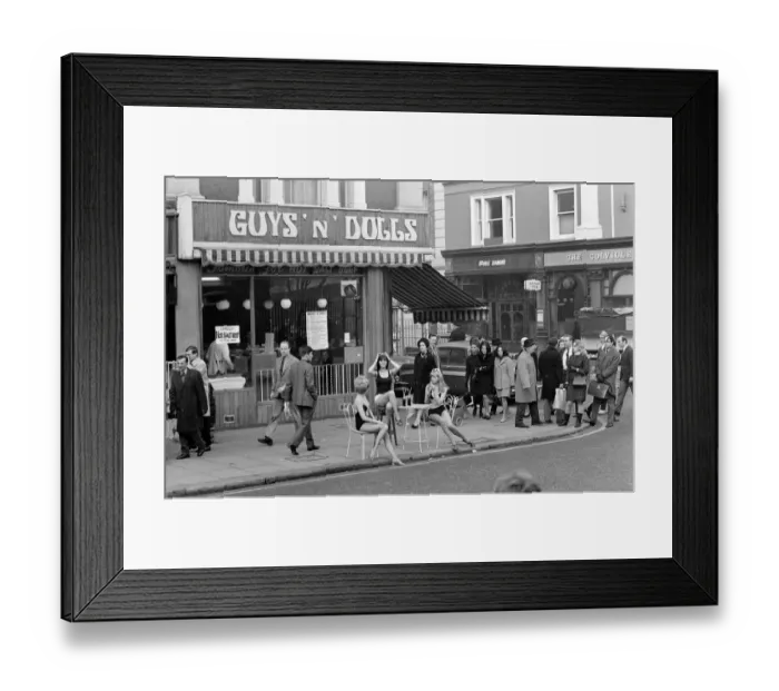 Framed Print : Models wearing swimsuits sit outside Guys and Dolls in the Kings Road Chelsea London Framed Print : Models wearing swimsuits sit outside Guys and Dolls in the Kings Road Chelsea London