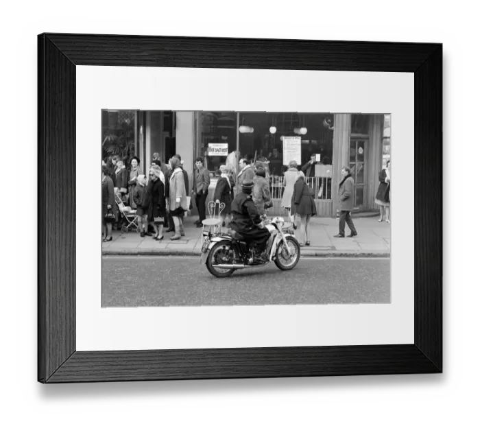 Framed Print : A motorcycle policeman orders three models wearing swimsuits sitting outside Guys