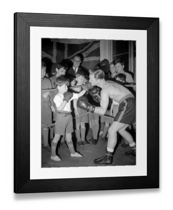 Framed Print : This young man is learning how to fight from a professional boxer. 1949