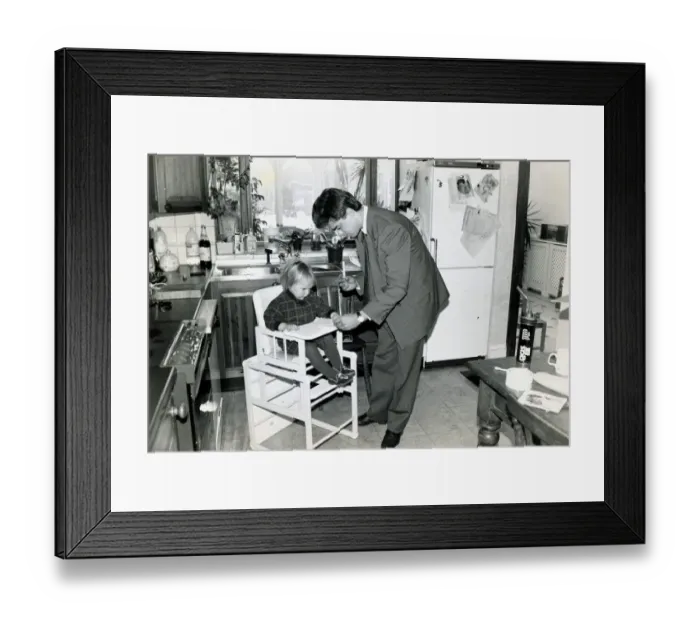 Framed Print : A man with his baby daughter in the kitchen of their home March 1991 1990s Framed Print : A man with his baby daughter in the kitchen of their home March 1991 1990s