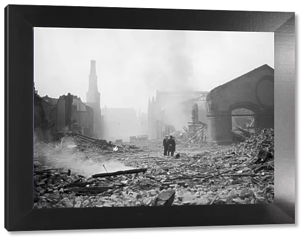 Bomb damage at Liverpool. Two people survey the damage caused by an air raid