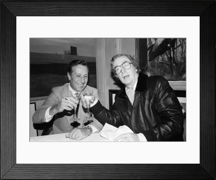 Framed Print : Author Frederick Forsyth having lunch with Michael Caine who starred in the film version Framed Print : Author Frederick Forsyth having lunch with Michael Caine who starred in the film version
