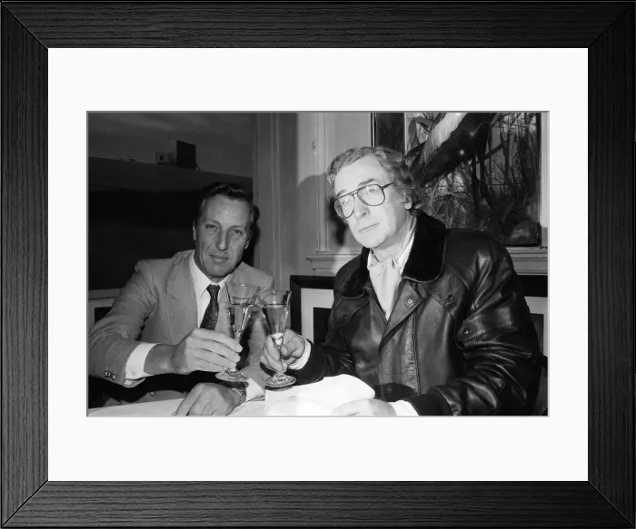 Framed Print : Author Frederick Forsyth having lunch with Michael Caine who starred in the film version Framed Print : Author Frederick Forsyth having lunch with Michael Caine who starred in the film version