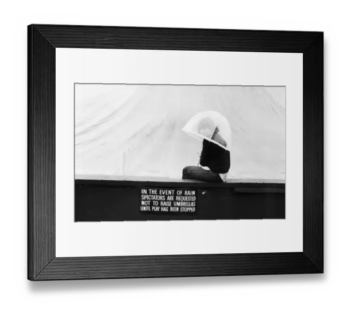 Framed Print : Spectator enduring the rain on Wimbledons centre court Framed Print : Spectator enduring the rain on Wimbledons centre court
