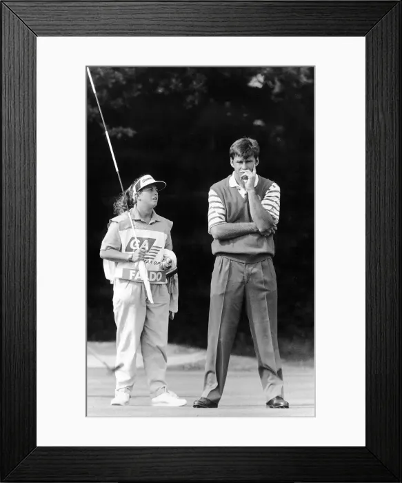Framed Print : Nick Faldo Golf with caddy Fanny Sunesson holding the flag look on to the putting green Framed Print : Nick Faldo Golf with caddy Fanny Sunesson holding the flag look on to the putting green