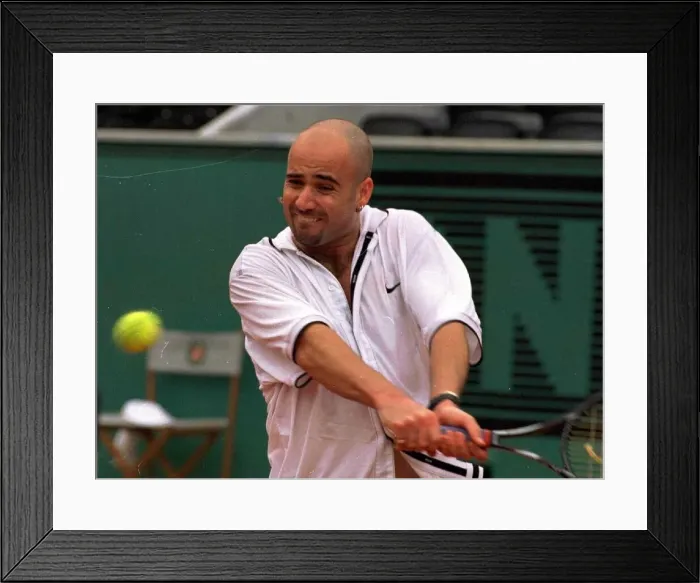 Framed Print : Andre Agassi tennis star in action in the rain during the French Open tennis tournament Framed Print : Andre Agassi tennis star in action in the rain during the French Open tennis tournament