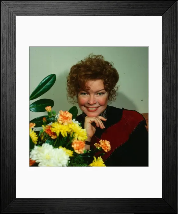 Framed Print : Ellen Burstyn actress March 1981 standing beside flowers hand at chin