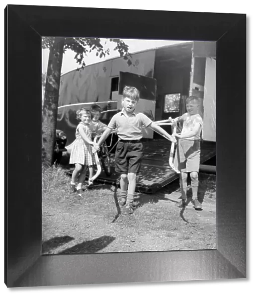 Children unloading a racing sulky, the light frame the jockey rides in during a trotting