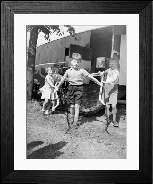 Framed Print : Children unloading a racing sulky, the light frame the jockey rides in during a trotting Framed Print : Children unloading a racing sulky, the light frame the jockey rides in during a trotting