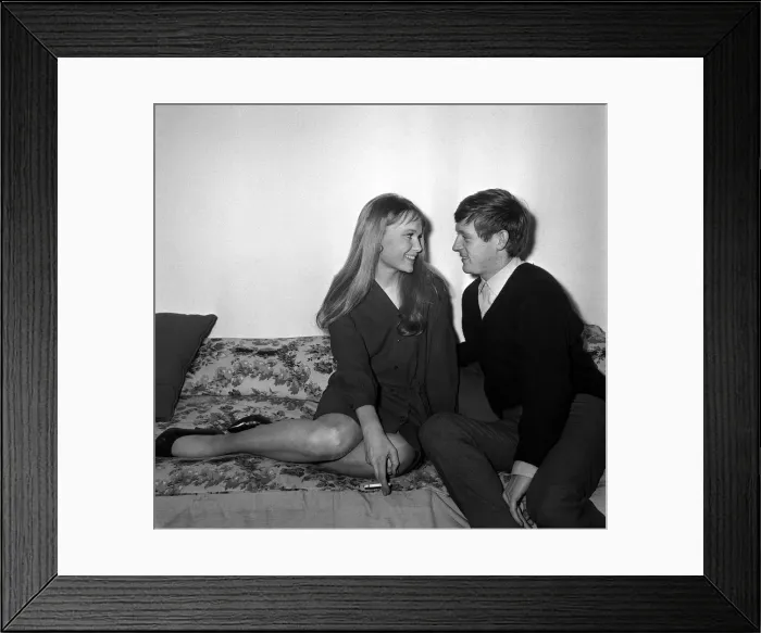 Framed Print : Actress Mia Farrow with singer John Leyton April 1964 sitting on sofa talking