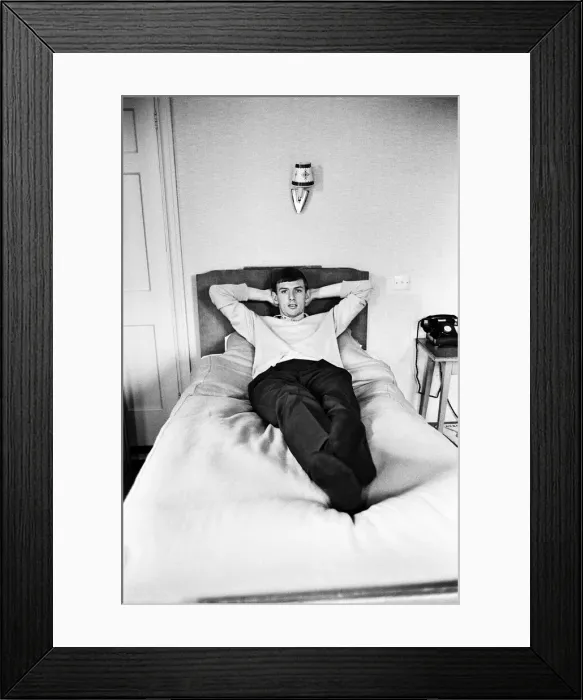 Framed Print : England footballer Martin Peters relaxes on the bed in his room at the team hotel in Framed Print : England footballer Martin Peters relaxes on the bed in his room at the team hotel in