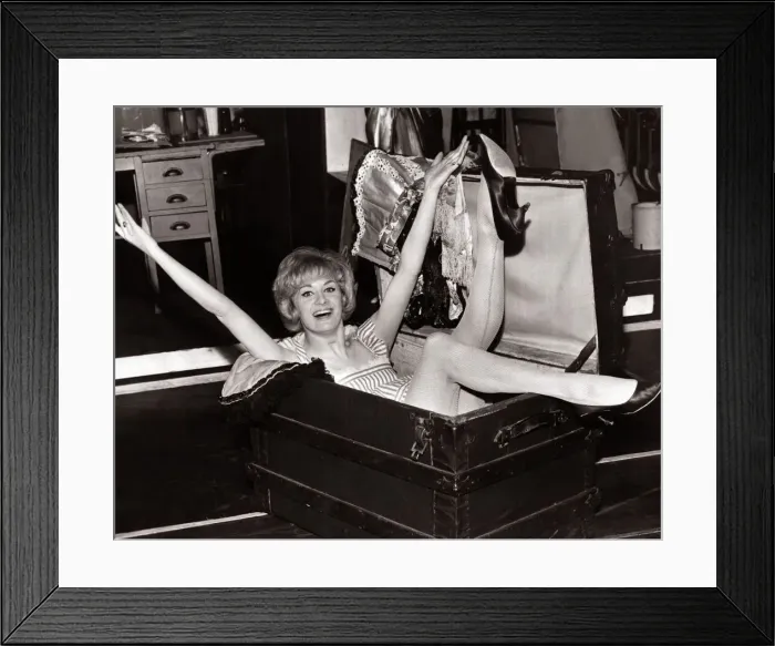 Framed Print : Pat Ramsay actress seated in a large wooden chest, backstage at the Alhambra Theatre Framed Print : Pat Ramsay actress seated in a large wooden chest, backstage at the Alhambra Theatre