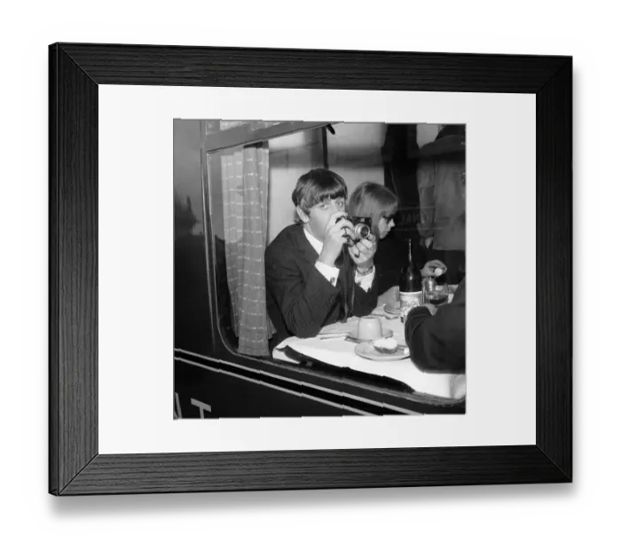 Framed Print : Ringo Starr with a cine camera and an actress in his compartment with the Beatles Framed Print : Ringo Starr with a cine camera and an actress in his compartment with the Beatles