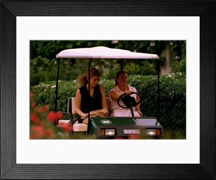 Framed Print : Nick Faldos new girlfriend Brenna gets a lift from his caddie Fanny