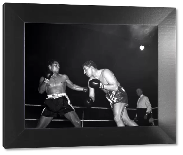 Joe Erskin of Wales throws a right at American Willie Pastrano when they met on the 24th