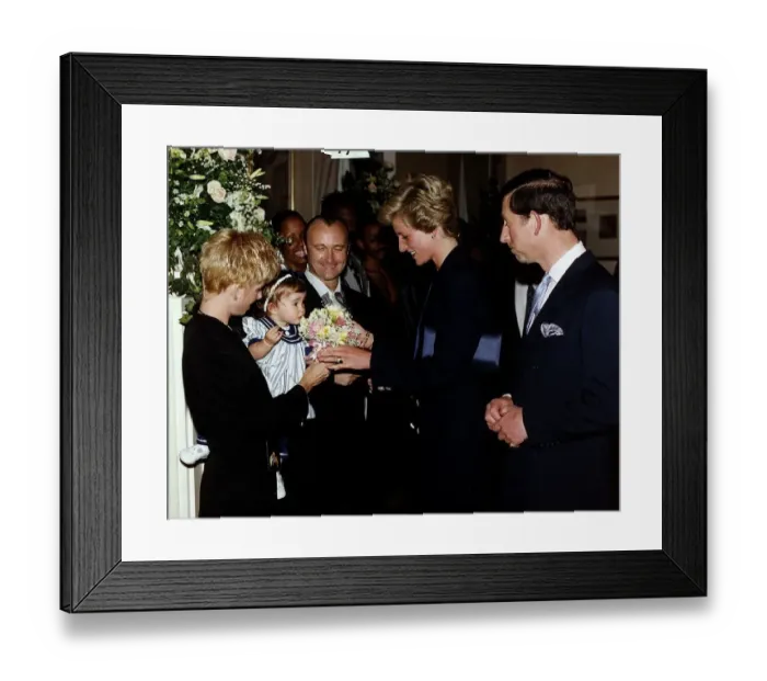 Framed Print : Singer and msusician Phil Collins with his family meeting Prince Charles