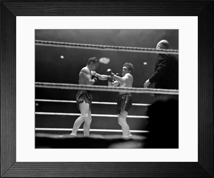 Framed Print : Freddie Mills (right) takes a left from Bruce Woodcock in their heavyweight fight