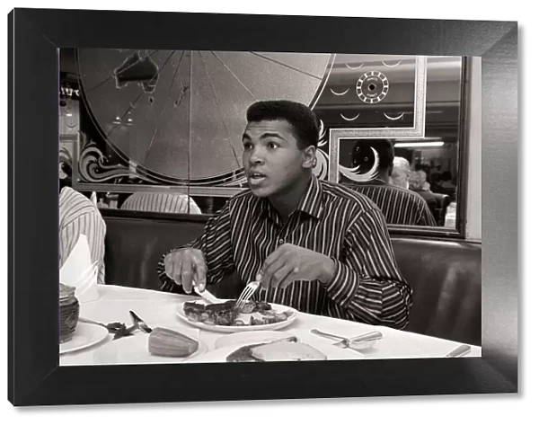 Cassius Clay eating Steaks at Isows restuarant in Brewer Street, Soho, London