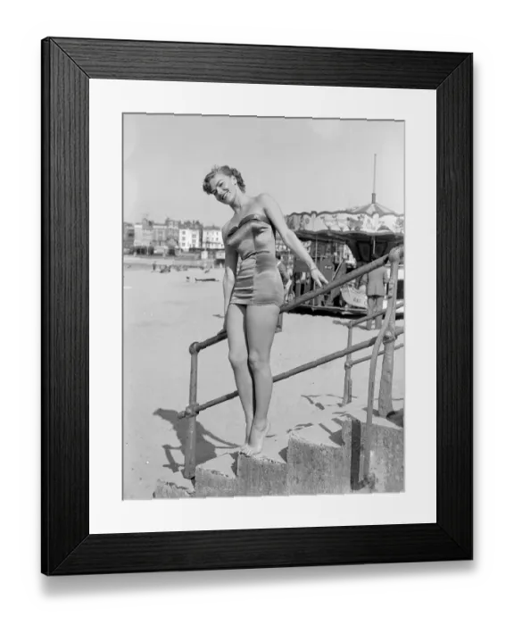 Framed Print : Clothing Beach wear swimsuits fashion April 1952 Model standing on steps wearing a