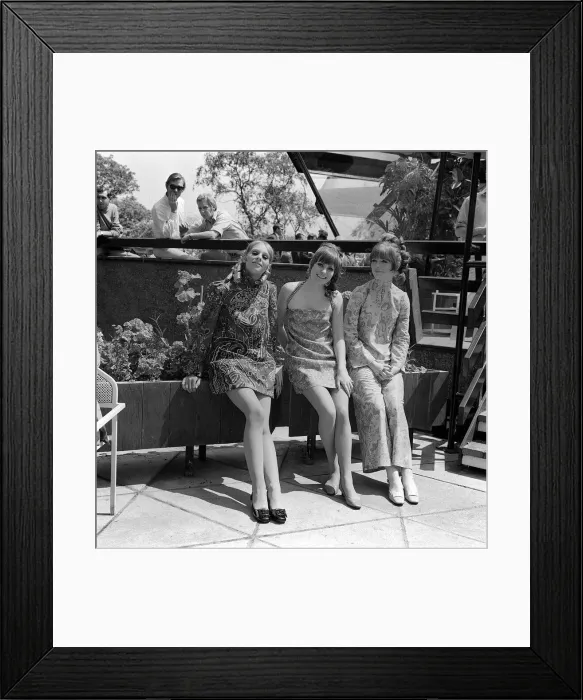 Framed Print : Socio Boutique in London shows of some of its new fashions Three girls sitting Framed Print : Socio Boutique in London shows of some of its new fashions Three girls sitting