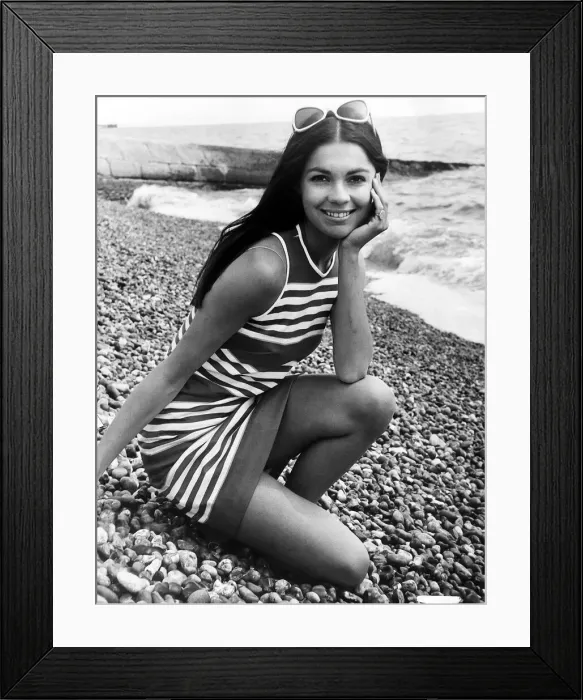 Framed Print : Virginia North Model posing on the beach in a striped dress resting her chin Framed Print : Virginia North Model posing on the beach in a striped dress resting her chin