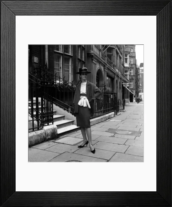Framed Print : Fashion model Mignon Madden models clothes designed by Graham Smith Wearing a hat