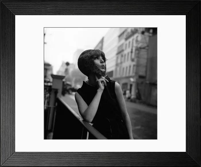 Framed Print : A model wears a bonnet style hat June 1965 She poses, looking upwards Framed Print : A model wears a bonnet style hat June 1965 She poses, looking upwards
