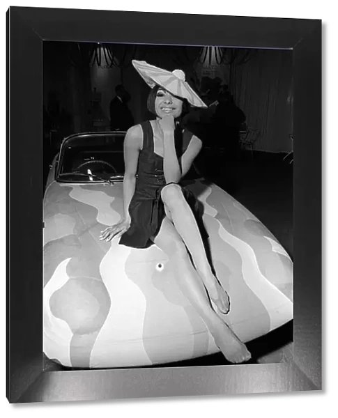 Fashion Clothing Hats April 1964 Fashion model Minerva Smith sitting on bonnet of