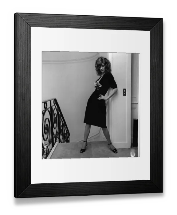 Framed Print : British model Vicki Hodge wearing black clingy dress with plunging neck line with posy Framed Print : British model Vicki Hodge wearing black clingy dress with plunging neck line with posy