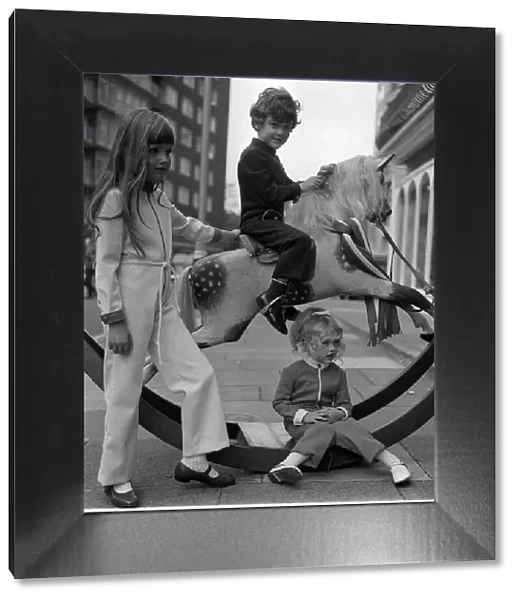 Fashion 1969 Children playing with a rocking horse in West Halkin Street selling