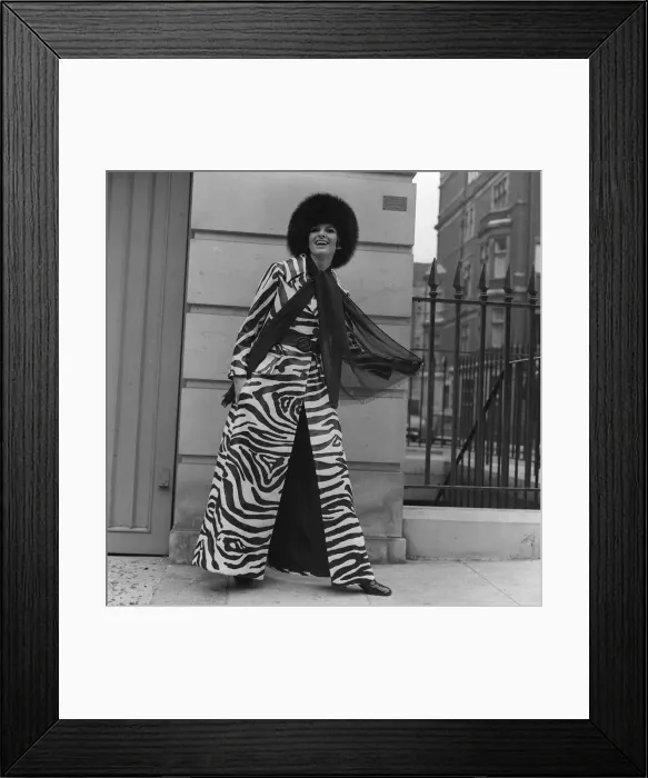 Framed Print : Christine Maxey wearing a zebra print trouser-suit and tunic top with black hat Framed Print : Christine Maxey wearing a zebra print trouser-suit and tunic top with black hat
